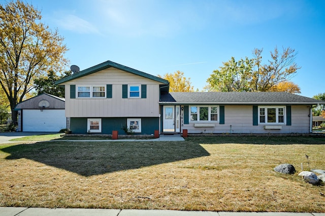 1613 Hartmann Dr, Schaumburg, IL 60193 - split level home featuring an outdoor structure, a detached garage, a front lawn, and concrete driveway