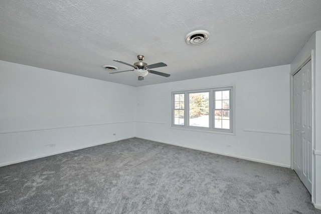 1613 Hartmann Dr, Schaumburg, IL 60193 - unfurnished bedroom with carpet flooring, a textured ceiling, a closet, baseboards, and ceiling fan