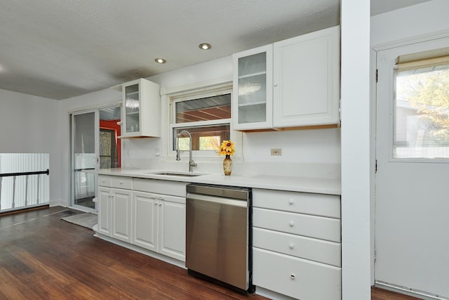 1613 Hartmann Dr, Schaumburg, IL 60193 - kitchen with dishwasher, a sink, light countertops, white cabinetry, and glass insert cabinets