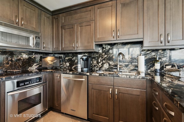505 N Lake Shore Dr Unit 4807, Chicago, IL 60611 - kitchen featuring appliances with stainless steel finishes, decorative backsplash, a sink, and dark stone counters