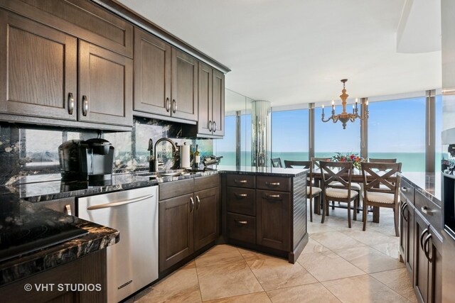505 N Lake Shore Dr Unit 4807, Chicago, IL 60611 - kitchen featuring stainless steel dishwasher, a sink, a chandelier, backsplash, and dark stone counters