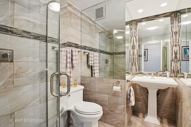 505 N Lake Shore Dr Unit 4807, Chicago, IL 60611 - full bathroom featuring tile walls, a stall shower, and toilet