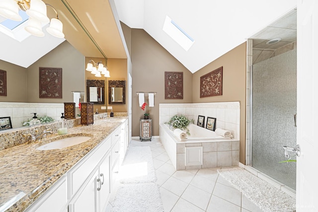 22802 Eider Ct, Plainfield, IL 60585 - bathroom with a skylight, tile patterned floors, double vanity, a garden tub, and high vaulted ceiling