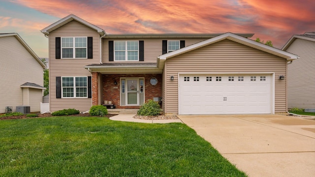 302 Gambel Ct, Normal, IL 61761 - traditional home featuring concrete driveway, a garage, a lawn, central AC unit, and brick siding