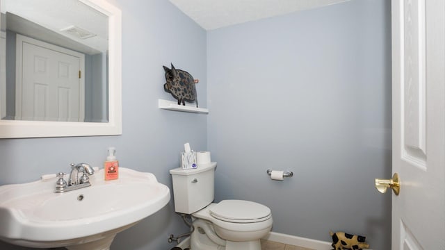 302 Gambel Ct, Normal, IL 61761 - bathroom with a sink, toilet, baseboards, and tile patterned flooring