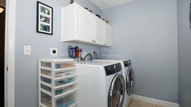 302 Gambel Ct, Normal, IL 61761 - laundry area with cabinet space, washer and dryer, light tile patterned flooring, and baseboards