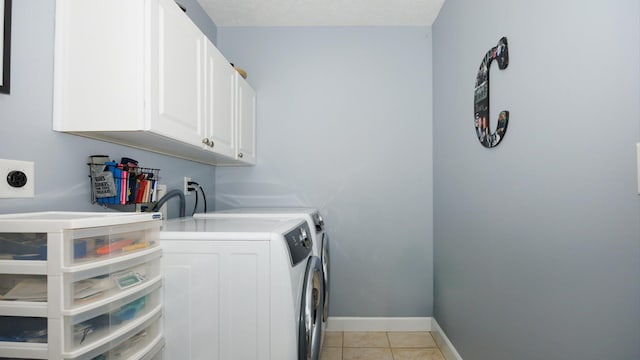 302 Gambel Ct, Normal, IL 61761 - laundry area with cabinet space, washer and clothes dryer, light tile patterned floors, and baseboards