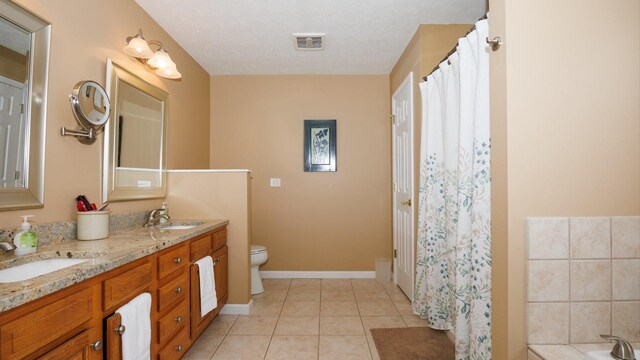 302 Gambel Ct, Normal, IL 61761 - bathroom with double vanity, toilet, tile patterned flooring, a tub, and baseboards
