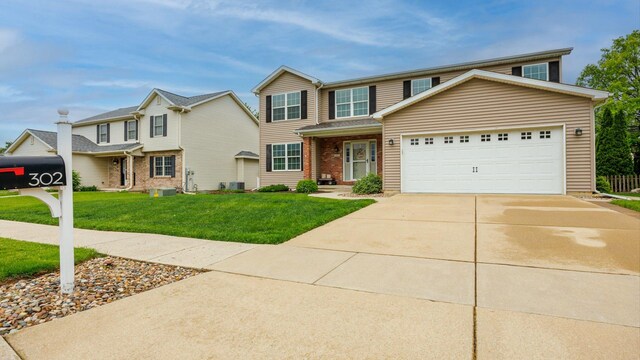 302 Gambel Ct, Normal, IL 61761 - traditional home with concrete driveway, a front yard, a garage, and central AC unit