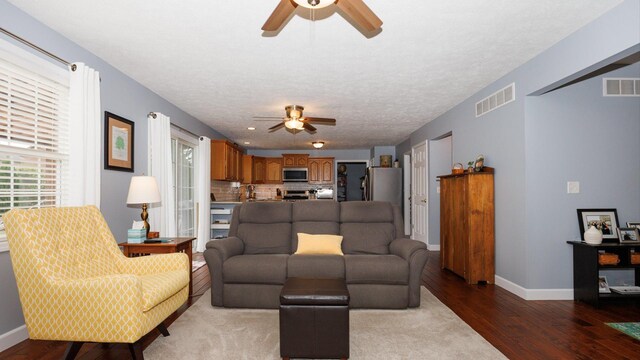 302 Gambel Ct, Normal, IL 61761 - living room with ceiling fan, light wood-type flooring, baseboards, and a textured ceiling