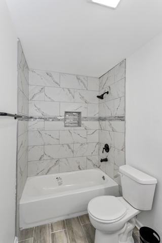 full bathroom with toilet, wood finished floors, and shower / bathtub combination