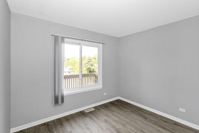 empty room with wood finished floors and baseboards