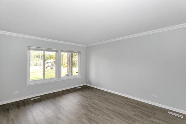 unfurnished room with baseboards, crown molding, and dark wood finished floors