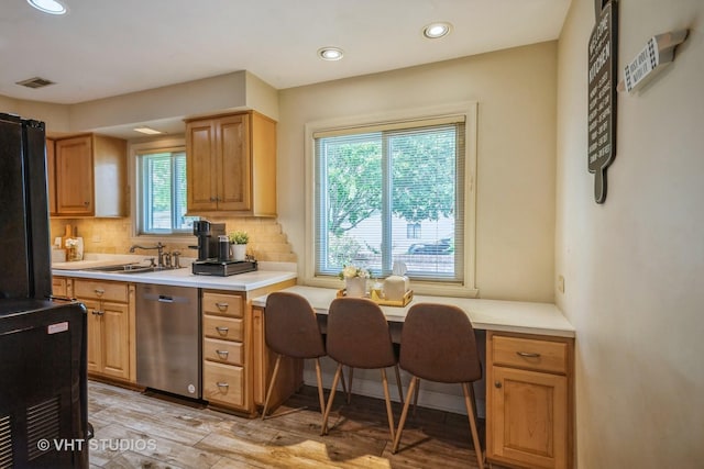 1109 Danvers Ct, Schaumburg, IL 60193 - kitchen featuring dishwasher, a sink, decorative backsplash, light wood-type flooring, and light countertops