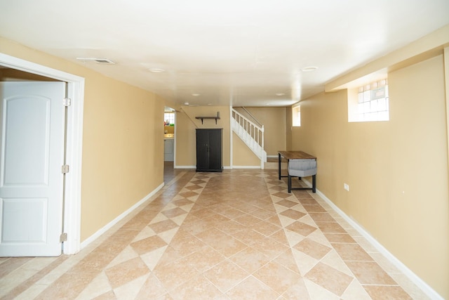 8743 S Constance Ave, Chicago, IL 60617 - basement featuring plenty of natural light, light tile patterned flooring, stairway, and baseboards