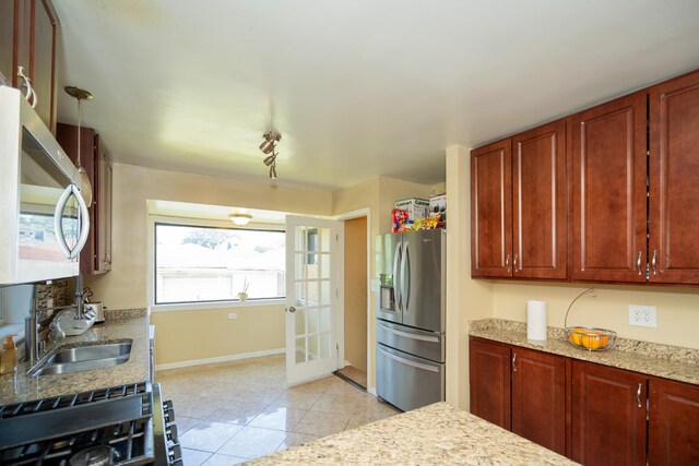 8743 S Constance Ave, Chicago, IL 60617 - kitchen with stainless steel appliances, a sink, light tile patterned floors, baseboards, and light stone counters