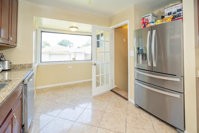8743 S Constance Ave, Chicago, IL 60617 - kitchen featuring appliances with stainless steel finishes, light tile patterned flooring, baseboards, and light stone counters