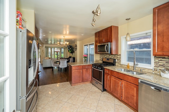 8743 S Constance Ave, Chicago, IL 60617 - kitchen with stainless steel appliances, a sink, a chandelier, a peninsula, and tasteful backsplash