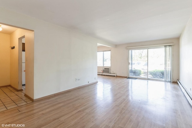 942 E Old Willow Rd Unit 101, Prospect Heights, IL 60070 - unfurnished room featuring light wood finished floors, a baseboard radiator, and baseboards
