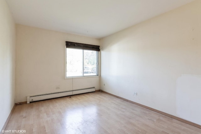 942 E Old Willow Rd Unit 101, Prospect Heights, IL 60070 - spare room with baseboard heating, light wood finished floors, and baseboards