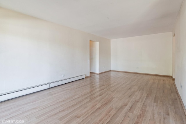 942 E Old Willow Rd Unit 101, Prospect Heights, IL 60070 - spare room featuring baseboard heating, light wood-type flooring, and baseboards