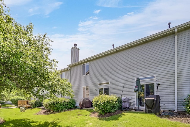 1163 Whispering Hills Dr, Naperville, IL 60540 - rear view of house with a chimney and a lawn