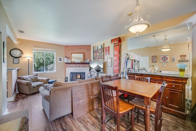 1163 Whispering Hills Dr, Naperville, IL 60540 - dining space featuring a warm lit fireplace and wood finished floors