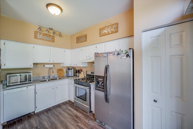 1163 Whispering Hills Dr, Naperville, IL 60540 - kitchen featuring appliances with stainless steel finishes, under cabinet range hood, dark wood-type flooring, a sink, and white cabinetry