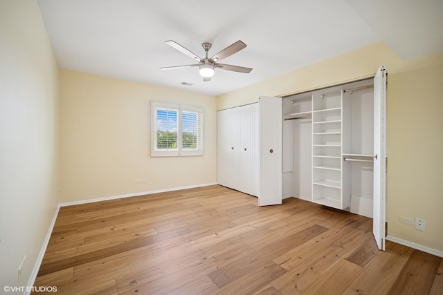 407 Ashland Ave Unit 6H, River Forest, IL 60305 - unfurnished bedroom featuring multiple closets, light wood-style flooring, baseboards, and a ceiling fan