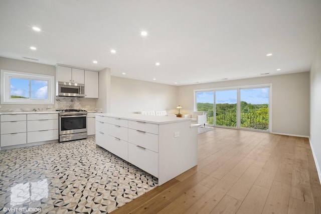 407 Ashland Ave Unit 6H, River Forest, IL 60305 - kitchen with stainless steel appliances, modern cabinets, light countertops, white cabinetry, and recessed lighting