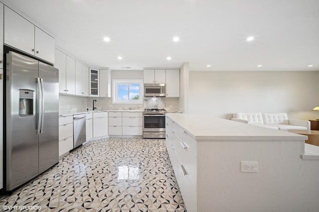 407 Ashland Ave Unit 6H, River Forest, IL 60305 - kitchen with appliances with stainless steel finishes, light countertops, recessed lighting, white cabinets, and a kitchen island