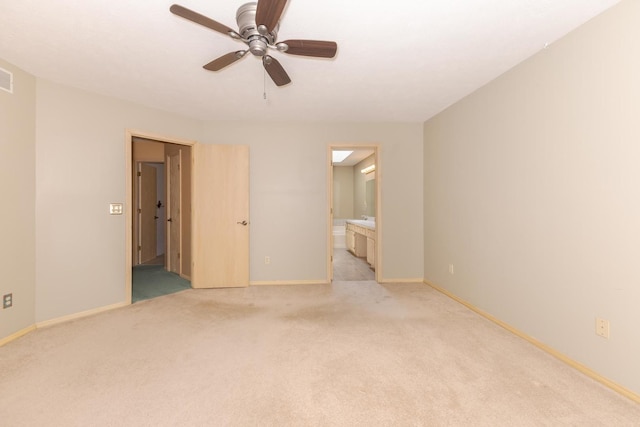 2321 Woodhavens Dr, Bloomington, IL 61701 - unfurnished bedroom featuring light carpet, ensuite bath, and a ceiling fan