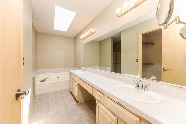 2321 Woodhavens Dr, Bloomington, IL 61701 - bathroom featuring double vanity, a skylight, a garden tub, and tile patterned floors