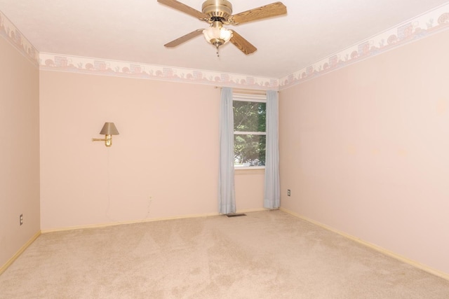 2321 Woodhavens Dr, Bloomington, IL 61701 - carpeted spare room featuring a ceiling fan and baseboards