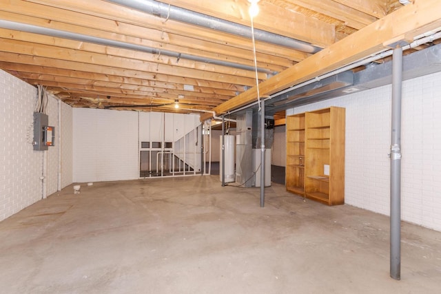 2321 Woodhavens Dr, Bloomington, IL 61701 - unfinished basement featuring electric panel, heating unit, and gas water heater
