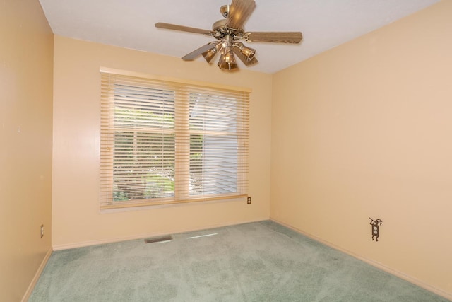 2321 Woodhavens Dr, Bloomington, IL 61701 - carpeted empty room featuring a ceiling fan and baseboards