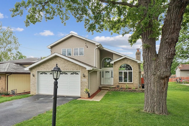 16212 Forest Ave, Oak Forest, IL 60452 - view of front of house with driveway, brick siding, a front yard, and a chimney