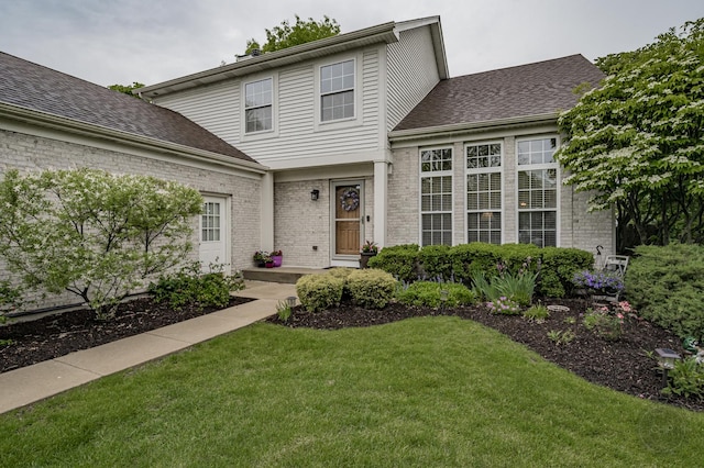 2693 Barrington Dr, Aurora, IL 60503 - view of front of property with a front lawn, brick siding, and roof with shingles