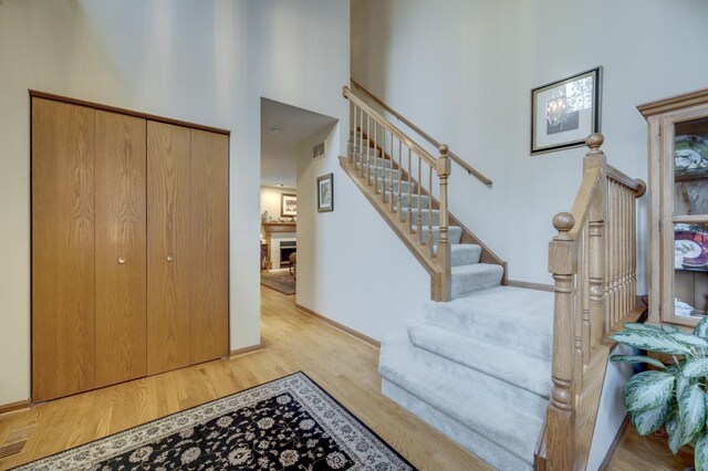 2693 Barrington Dr, Aurora, IL 60503 - entryway featuring light wood finished floors, a towering ceiling, stairway, and baseboards