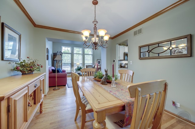 2693 Barrington Dr, Aurora, IL 60503 - dining space featuring a chandelier, ornamental molding, and light wood finished floors