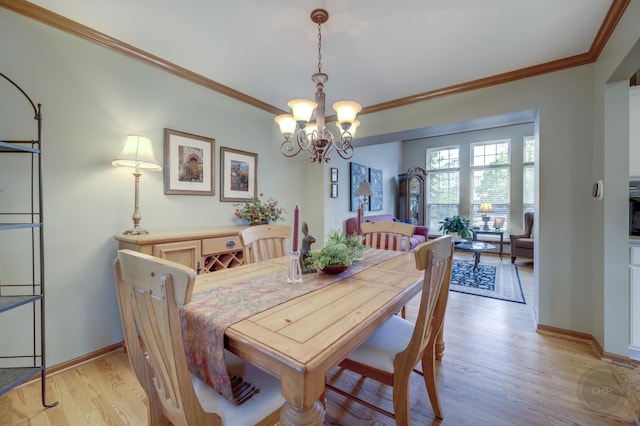 2693 Barrington Dr, Aurora, IL 60503 - dining room with a chandelier, light wood-style floors, baseboards, and ornamental molding