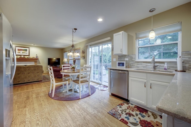2693 Barrington Dr, Aurora, IL 60503 - kitchen with appliances with stainless steel finishes, a sink, light wood-type flooring, white cabinets, and recessed lighting