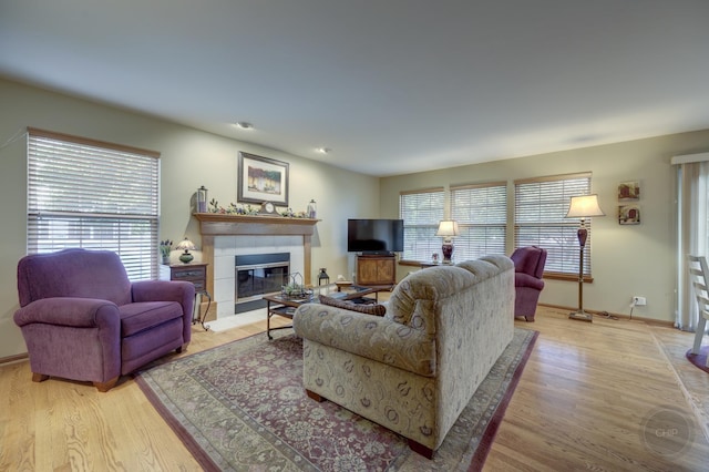 2693 Barrington Dr, Aurora, IL 60503 - living room featuring healthy amount of natural light, light wood-style floors, and a glass covered fireplace
