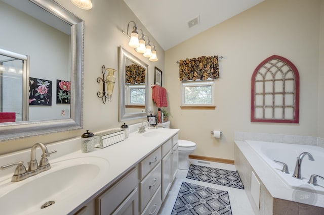 2693 Barrington Dr, Aurora, IL 60503 - bathroom featuring vaulted ceiling, a garden tub, double vanity, toilet, and baseboards