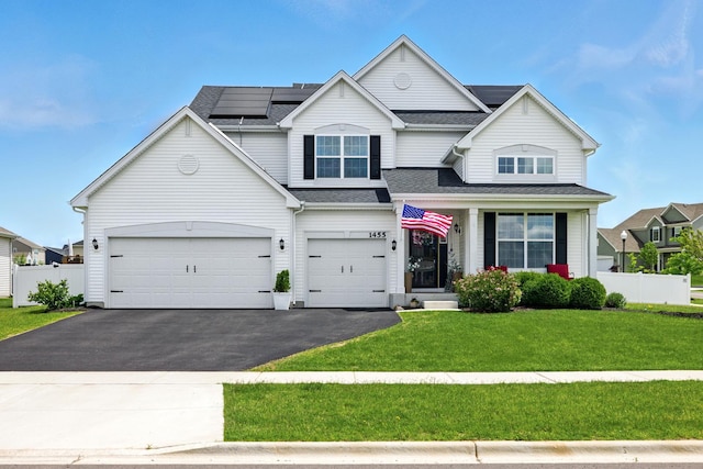1455 Highbrook Ave, Hampshire, IL 60140 - view of front of house with driveway, solar panels, a garage, and a shingled roof