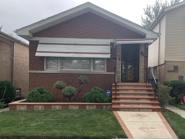 9323 S Normal Ave, Chicago, IL 60620 - view of front of home featuring brick siding and a front yard