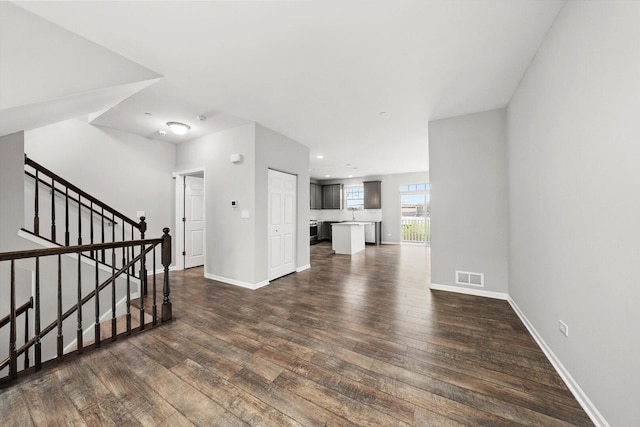 1413 N Charles Ave, Naperville, IL 60563 - unfurnished living room featuring dark wood-style flooring, baseboards, stairway, and recessed lighting