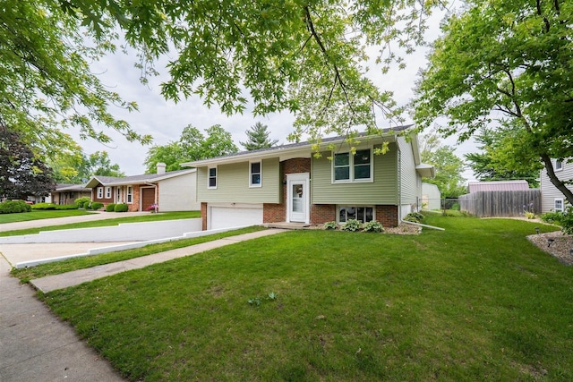 817 N Mohave Dr, Pontiac, IL 61764 - raised ranch featuring a garage, concrete driveway, and brick siding