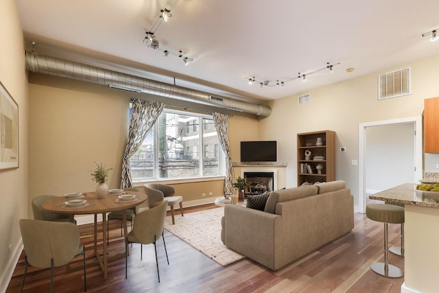 4751 N Artesian Ave Unit 206, Chicago, IL 60625 - living room featuring track lighting, wood finished floors, baseboards, and a high end fireplace