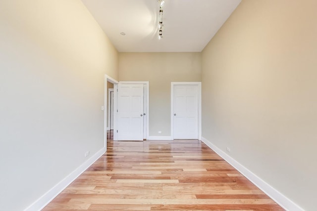 4751 N Artesian Ave Unit 206, Chicago, IL 60625 - spare room with light wood-type flooring, baseboards, and a high ceiling